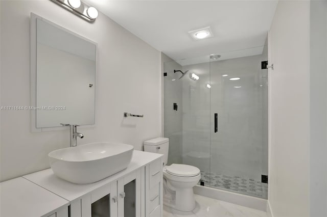 bathroom with walk in shower, vanity, and toilet