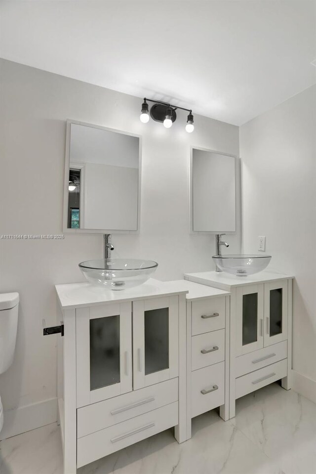 bathroom featuring vanity and toilet