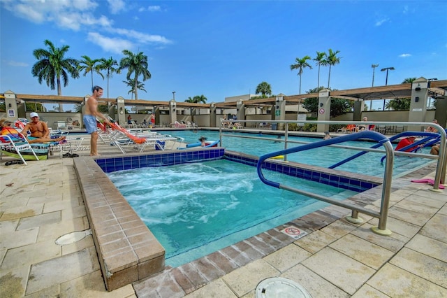 view of swimming pool featuring a community hot tub