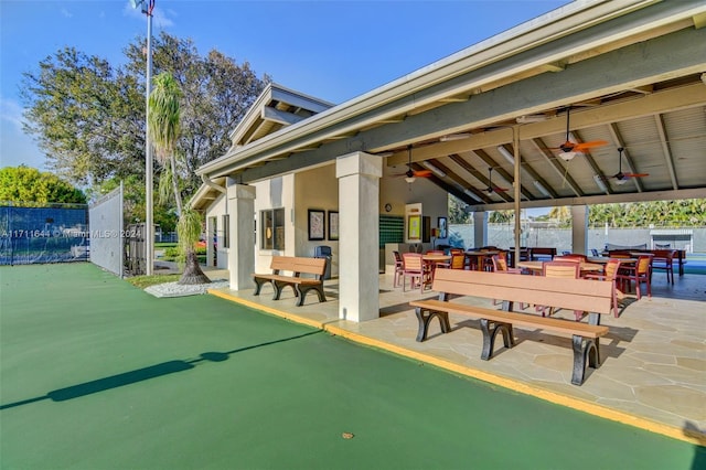 exterior space with ceiling fan