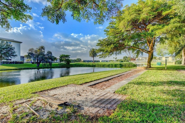 view of community with a water view and a yard