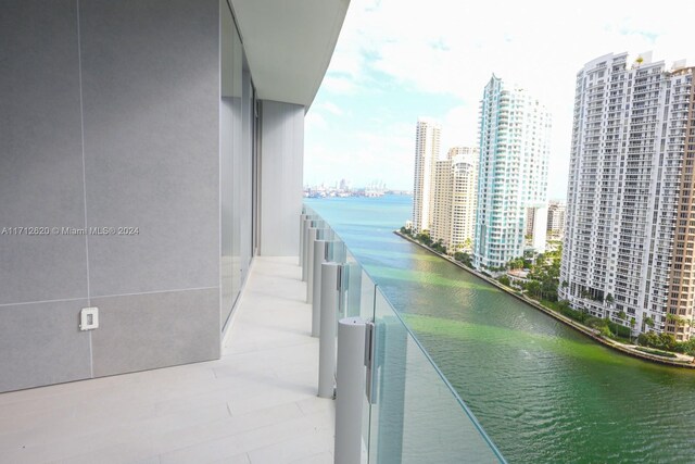 empty room featuring a water view and floor to ceiling windows