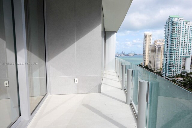 unfurnished room featuring expansive windows and a water view