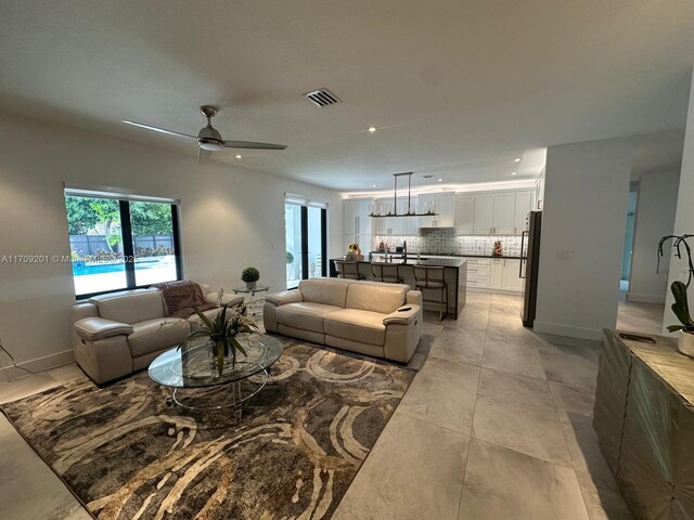 bedroom with a raised ceiling and ceiling fan