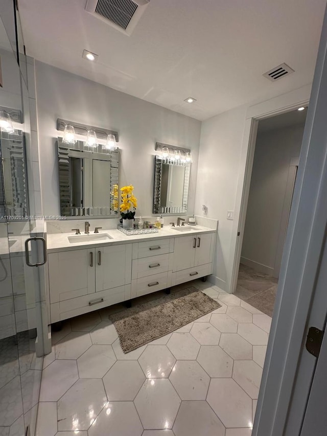 bathroom with vanity, tile patterned floors, and a shower with door