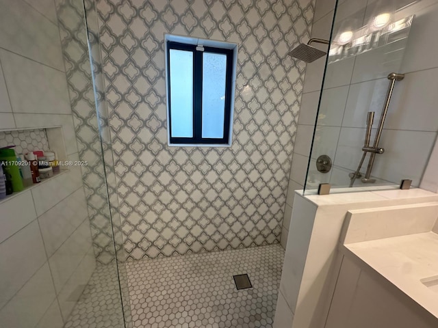 bathroom with vanity and tiled shower