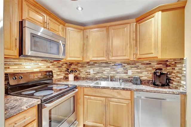 kitchen with decorative backsplash, light brown cabinetry, sink, and appliances with stainless steel finishes