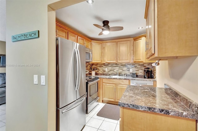 kitchen featuring light brown cabinetry, tasteful backsplash, stainless steel appliances, ceiling fan, and sink