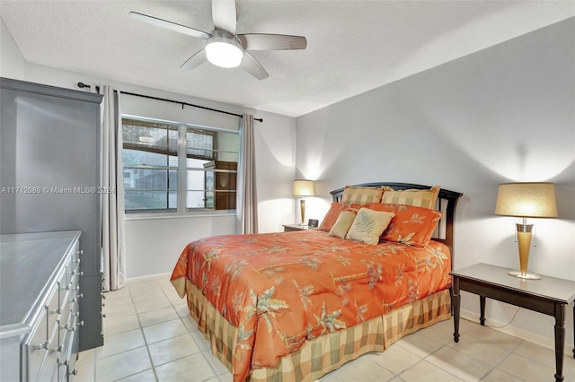 tiled bedroom with a textured ceiling and ceiling fan