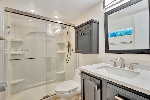 bathroom with vanity, toilet, and walk in shower