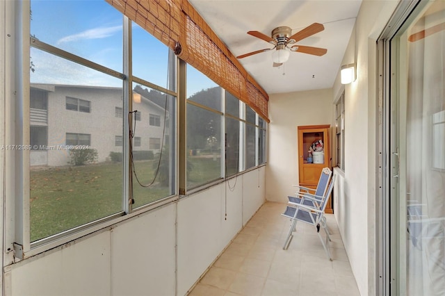 unfurnished sunroom featuring a wealth of natural light and ceiling fan