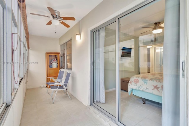 interior space featuring ceiling fan, light tile patterned flooring, and a closet