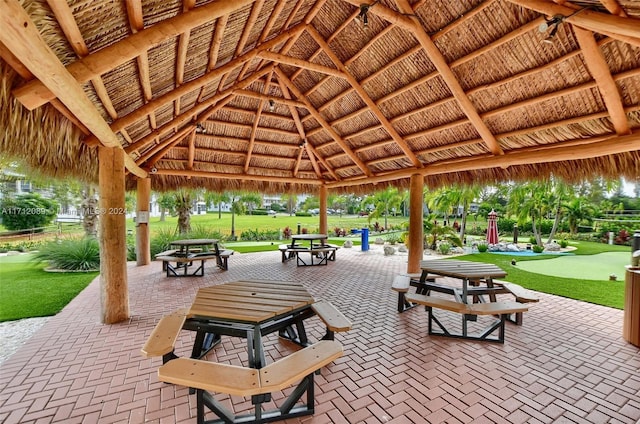 surrounding community with a gazebo and a yard