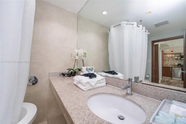 bathroom with sink and tile walls