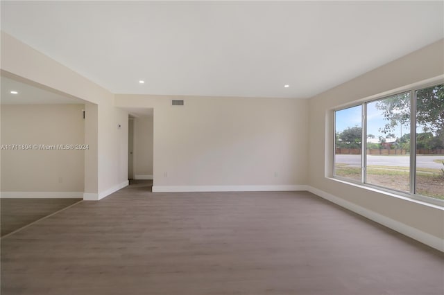 unfurnished room with dark hardwood / wood-style flooring