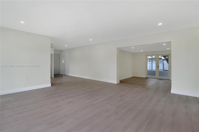 unfurnished room with french doors and light hardwood / wood-style floors