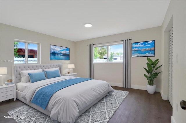 bedroom featuring dark hardwood / wood-style floors and multiple windows