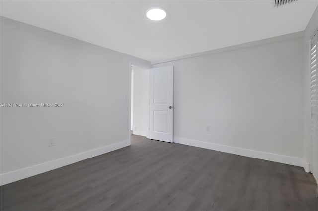 spare room featuring dark hardwood / wood-style flooring