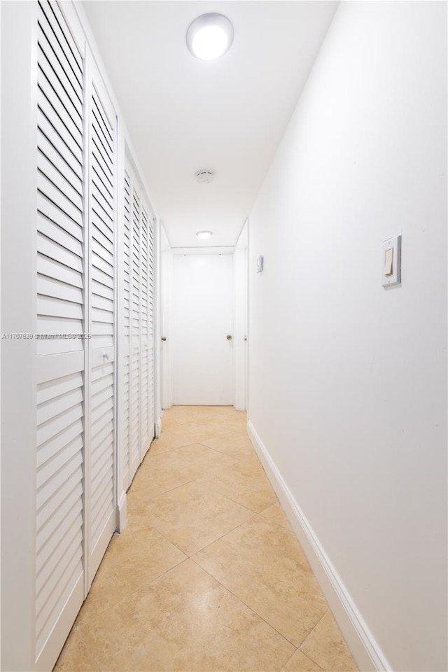 hallway featuring light tile patterned floors