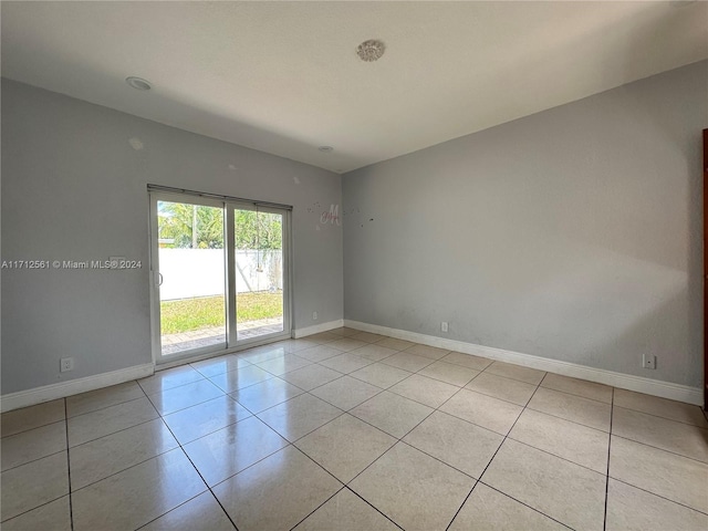 spare room with light tile patterned floors