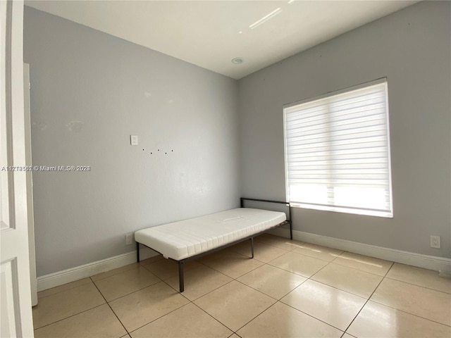 unfurnished bedroom featuring light tile patterned floors