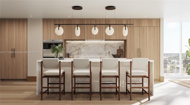 bar featuring a wall of windows, stainless steel oven, light wood-type flooring, and pendant lighting