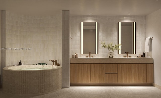 bathroom featuring tile walls, tile patterned floors, vanity, and a bathing tub