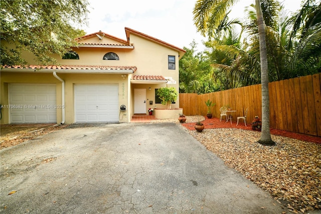 mediterranean / spanish house with a garage