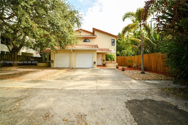 mediterranean / spanish-style home with a garage