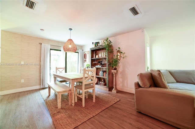 dining space featuring wood-type flooring