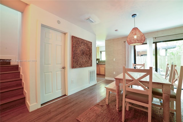 dining space with dark wood-type flooring