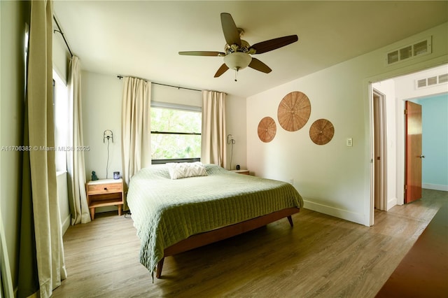 bedroom featuring hardwood / wood-style flooring and ceiling fan