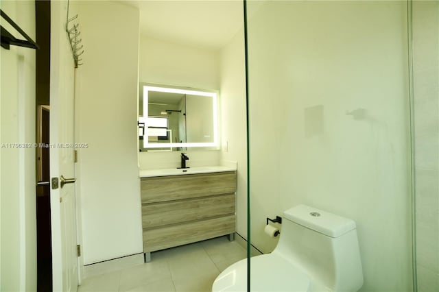 bathroom featuring tile patterned floors, vanity, and toilet