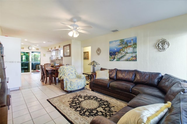 tiled living room with ceiling fan