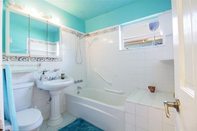 bathroom featuring shower / tub combination, toilet, and tile walls