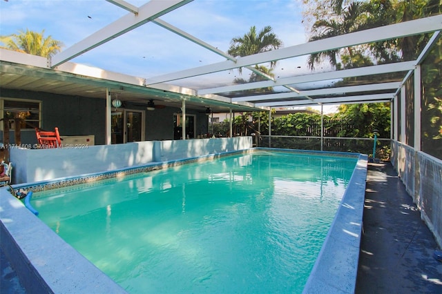 view of pool featuring glass enclosure