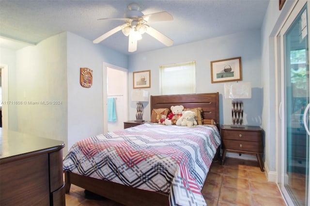 tiled bedroom featuring ceiling fan, a textured ceiling, and access to outside