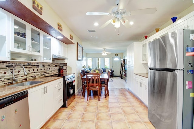 kitchen featuring white cabinets, appliances with stainless steel finishes, tasteful backsplash, and sink