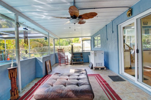 sunroom / solarium featuring ceiling fan