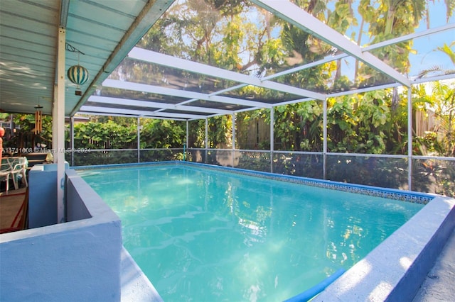 view of swimming pool featuring glass enclosure