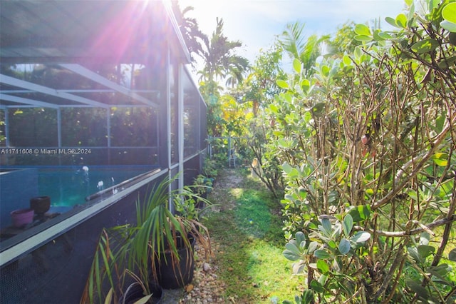 exterior space with glass enclosure and a swimming pool