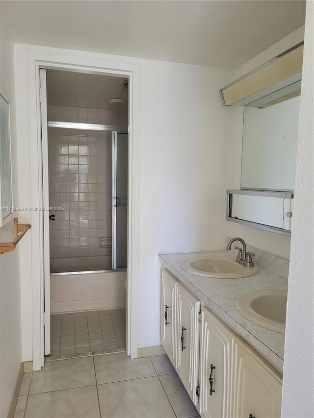 bathroom with double vanity, tile patterned flooring, a sink, and tub / shower combination