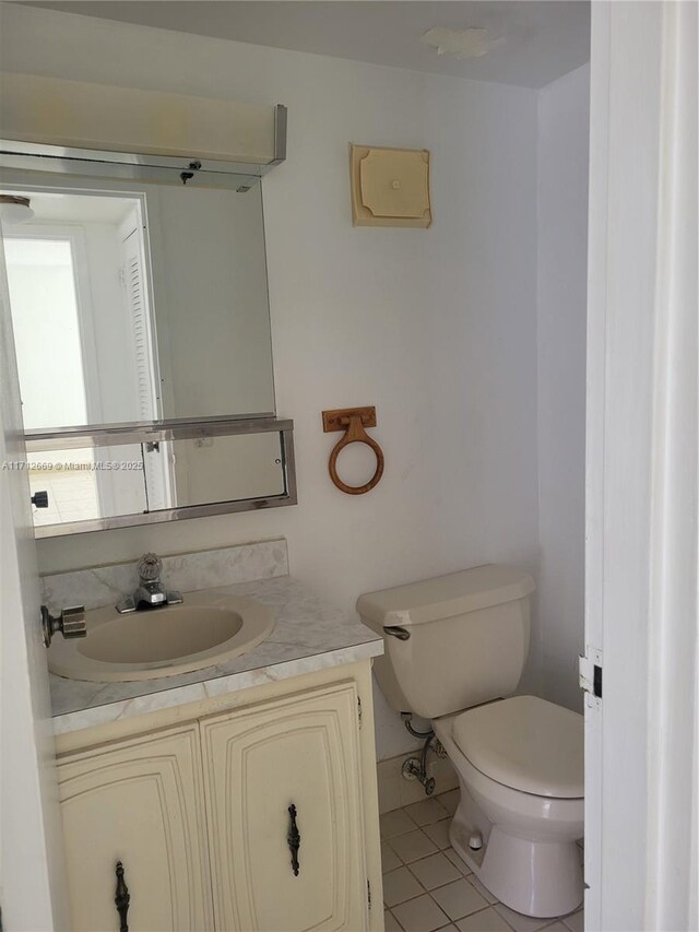 bathroom featuring vanity, toilet, and tile patterned floors