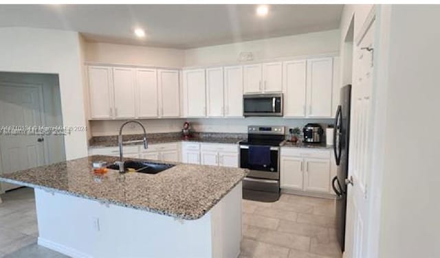 kitchen featuring sink, white cabinets, a center island with sink, and appliances with stainless steel finishes