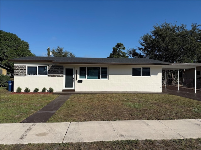 single story home with a front yard and a carport