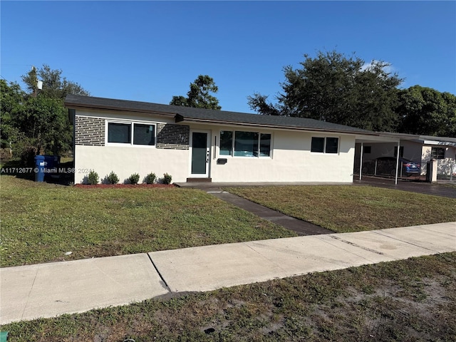 single story home with a carport and a front lawn