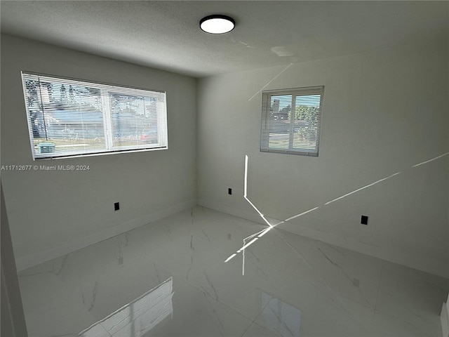 empty room with a textured ceiling