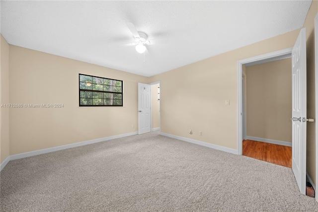 carpeted empty room with ceiling fan