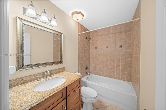 full bathroom with tile patterned flooring, tiled shower / bath combo, toilet, and vanity