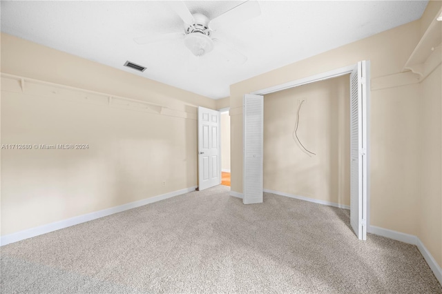 unfurnished bedroom with carpet, ceiling fan, and a closet